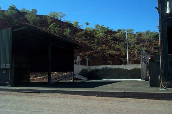 A fenced in area with a building in the background