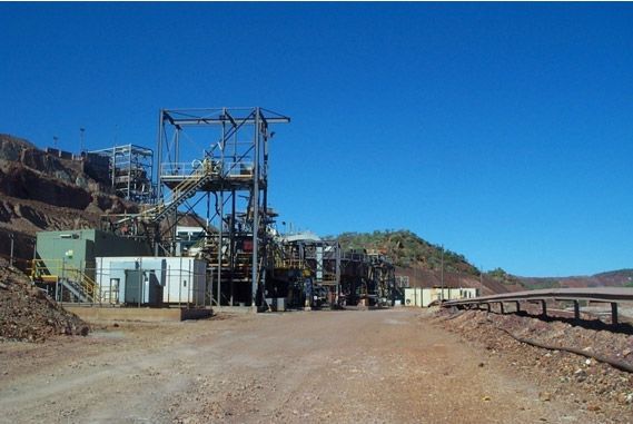 A large building with a lot of machinery in front of it