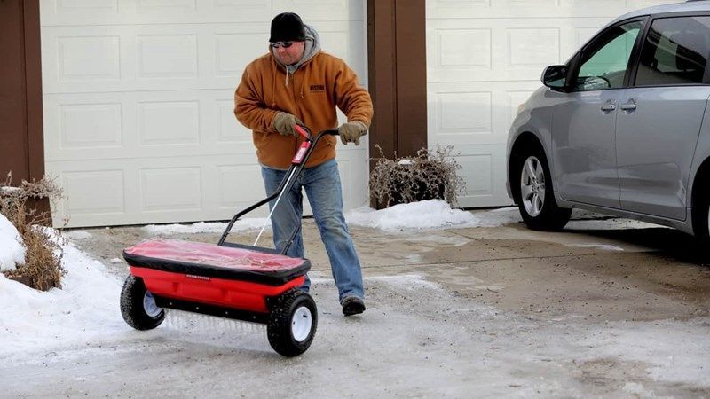 Man Operating A Red Spreader — Destin, FL — Destin Discount Granite And Cabinets