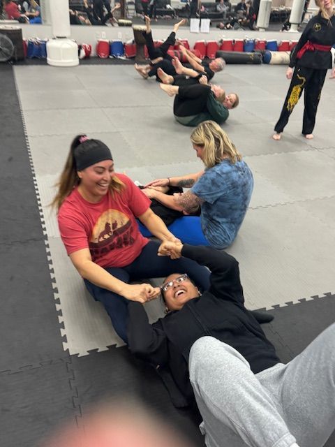 A woman wearing a red shirt with the word karate on it