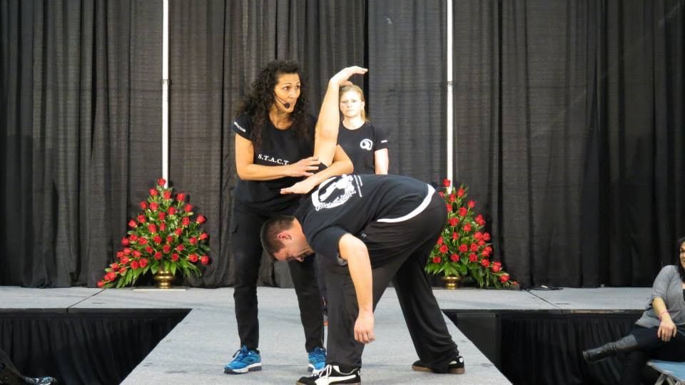A man and a woman are dancing on a stage.
