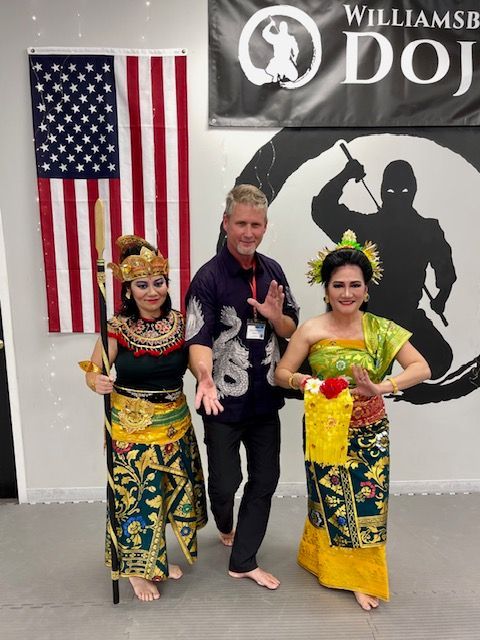 A man and two women pose in front of a banner that says williamsb dojo