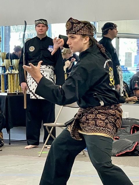 A group of people are practicing martial arts in front of a mirror.