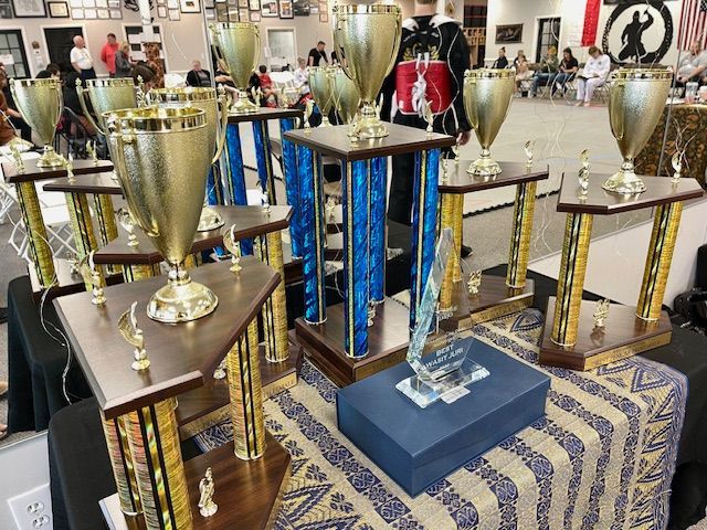 A bunch of trophies are sitting on a table