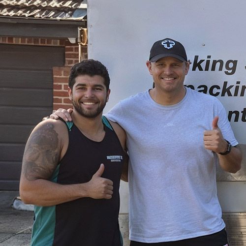 Brendon Goddard and a Master Relocations staff member smiling at the camera giving a thumbs up.