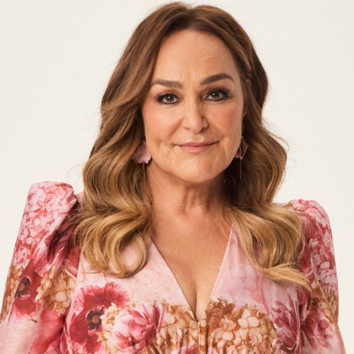 Kate Lambrook is wearing a pink floral dress and earrings.