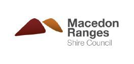 The macedonia ranges shire council logo is a red and orange triangle.