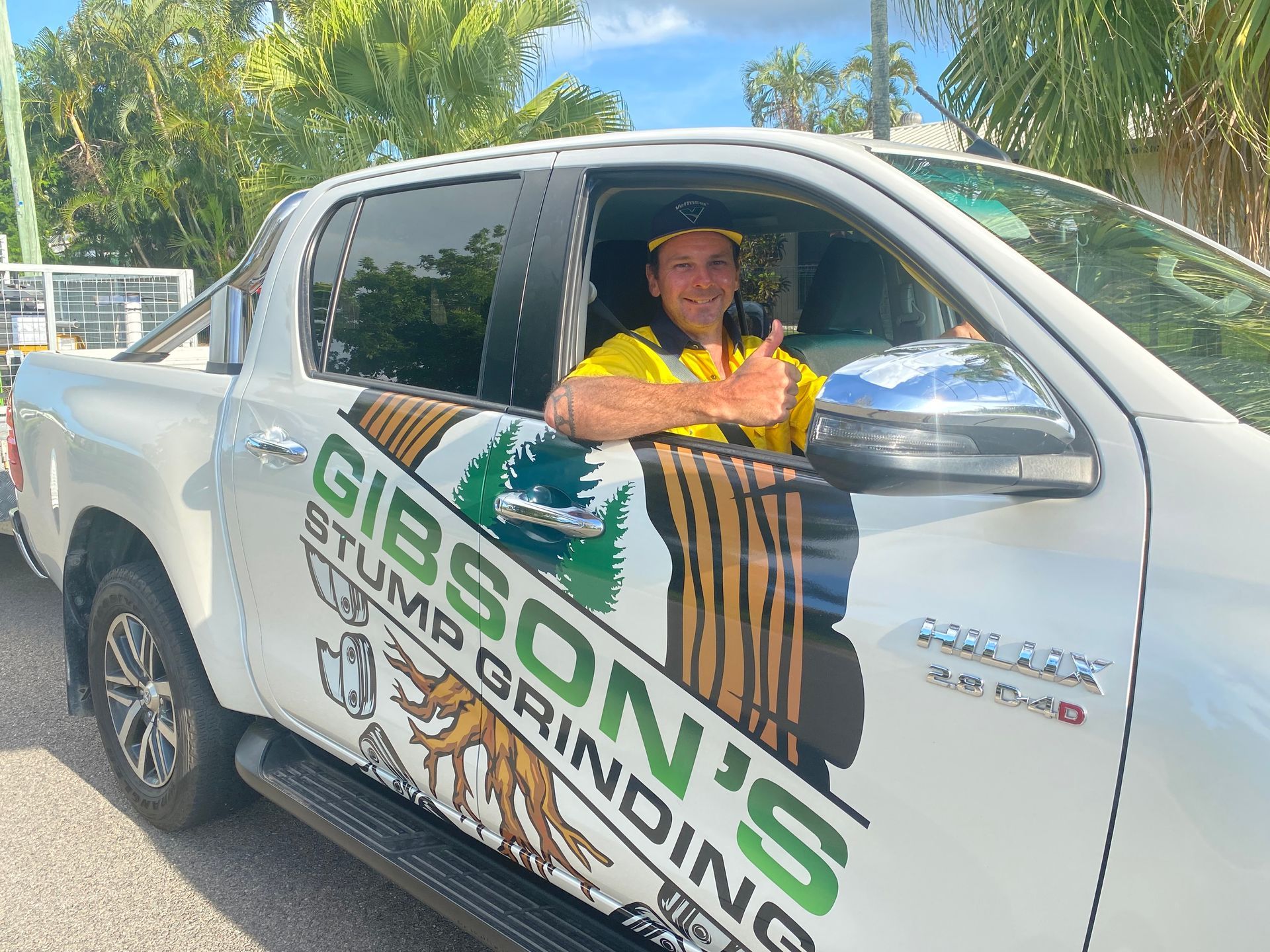 A Machine Is Stump Grinding a Tree Stump in A Yard — Stump Removal in Townsville, QLD