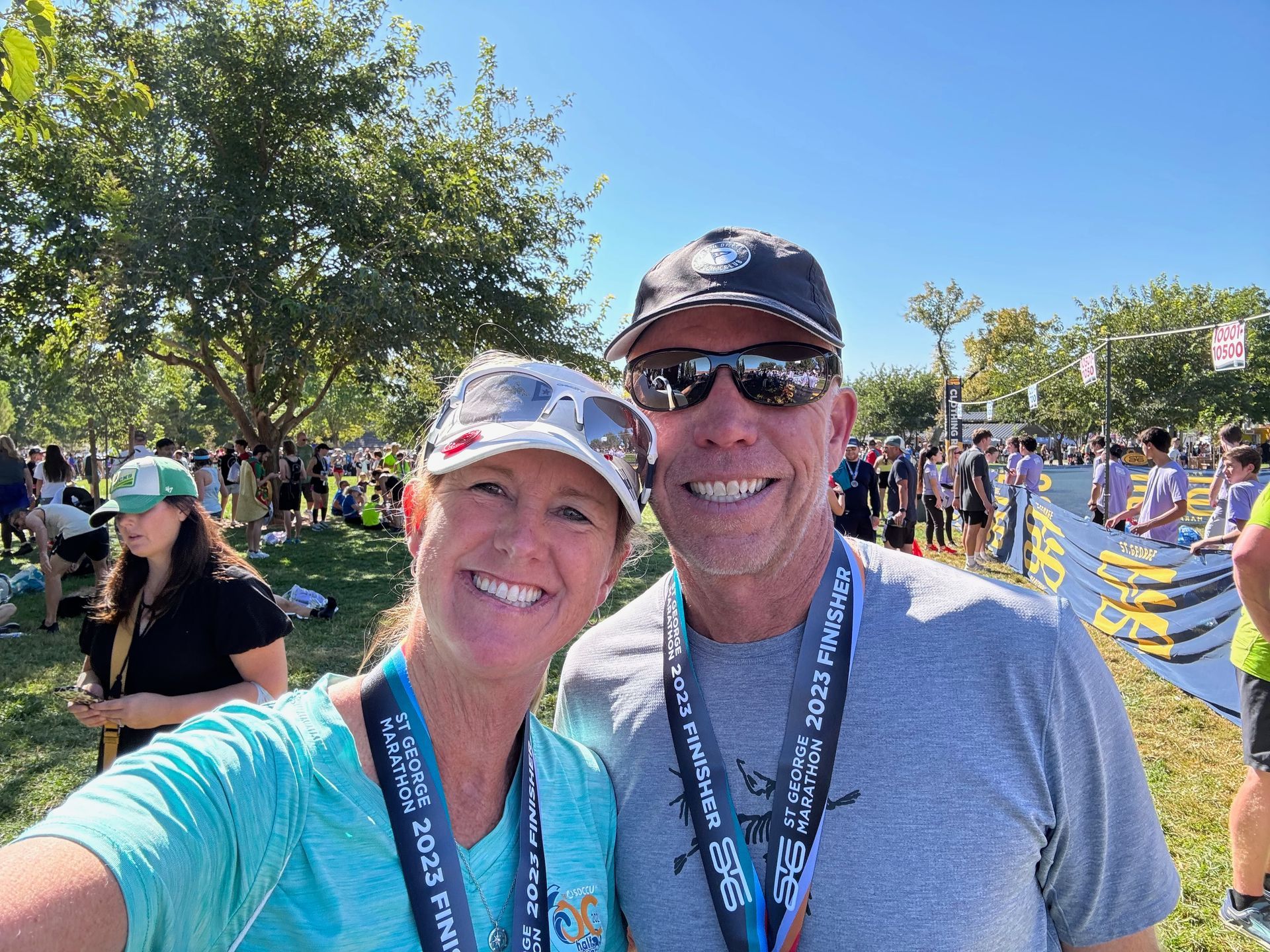 A man and a woman are posing for a picture at a race.