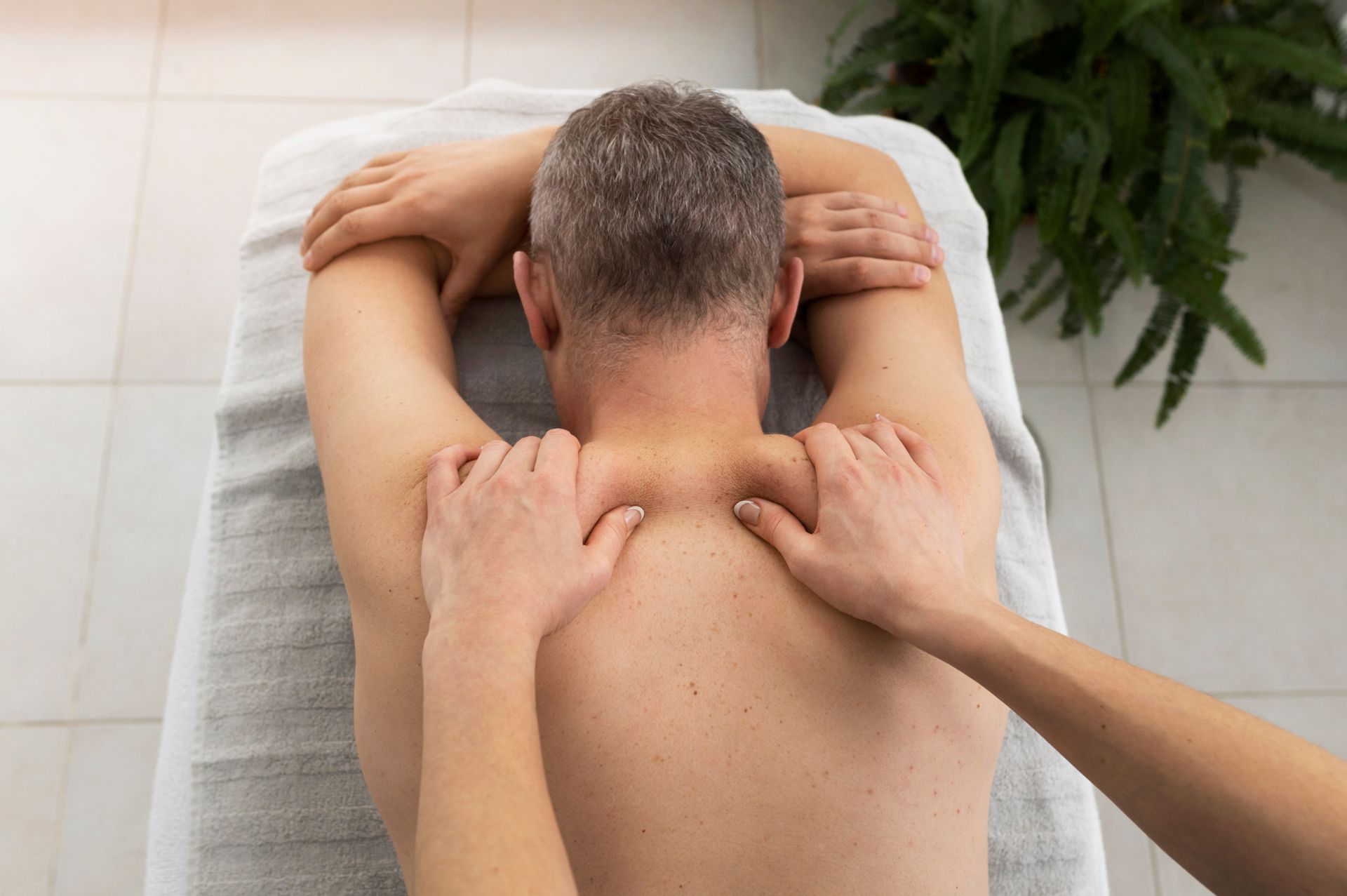 A man is getting a massage on his back in a spa.