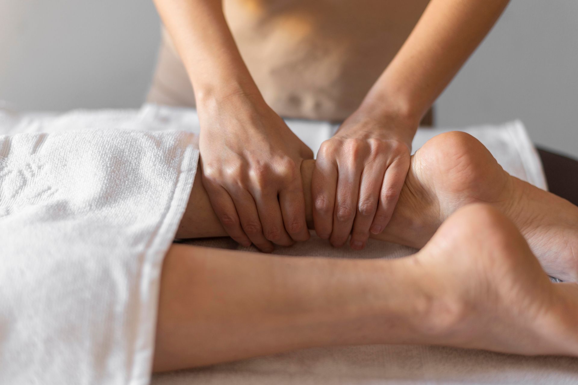A woman is getting a massage on her leg in a spa.