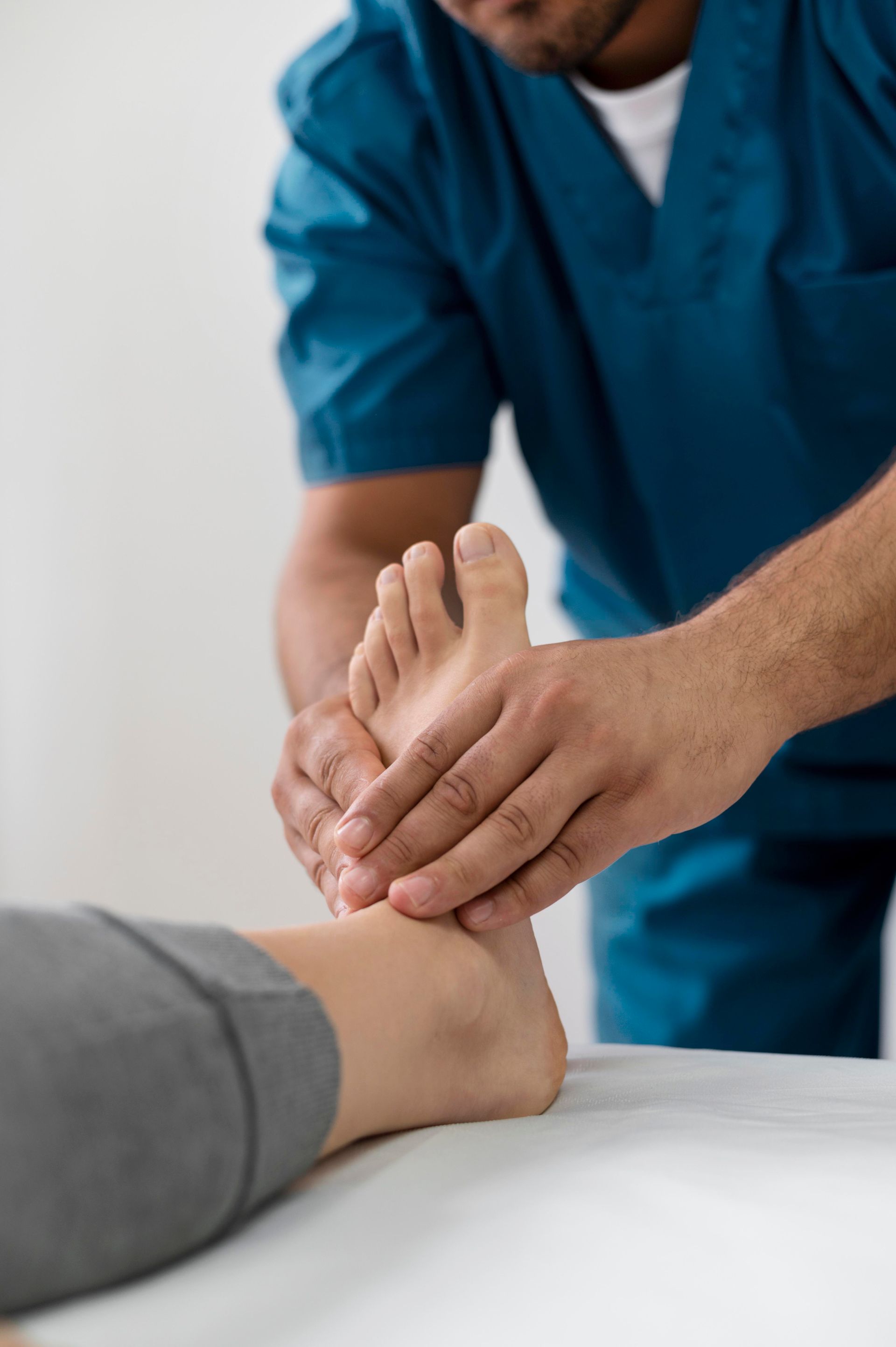 A doctor is giving a foot massage to a patient.