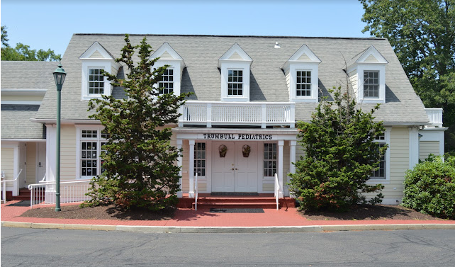 A white house with a gray roof and a sign that says ' tower millers ' on it
