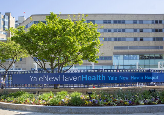 A large building with a sign that says yale new haven health