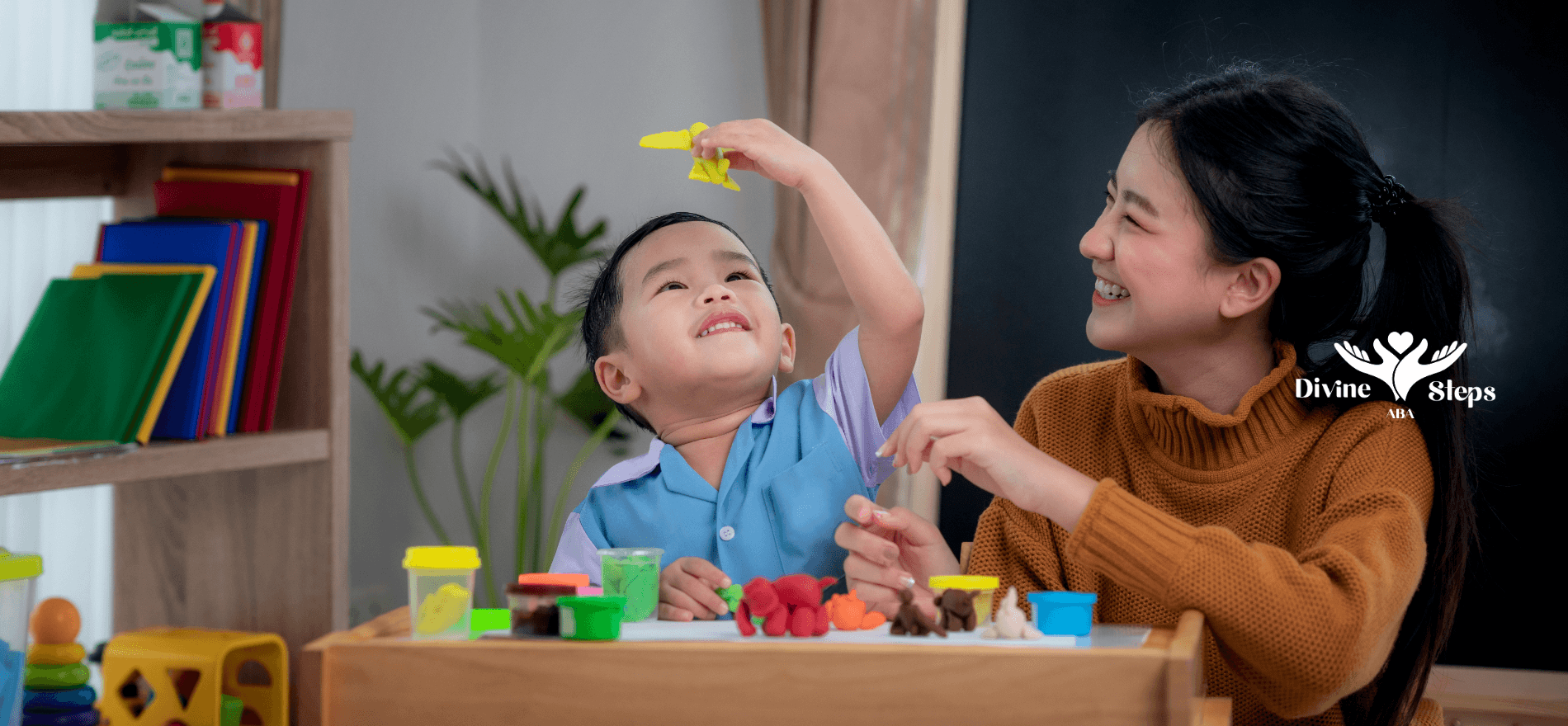 Therapist engaging autistic child in play-based activity with modeling clay to support fine motor