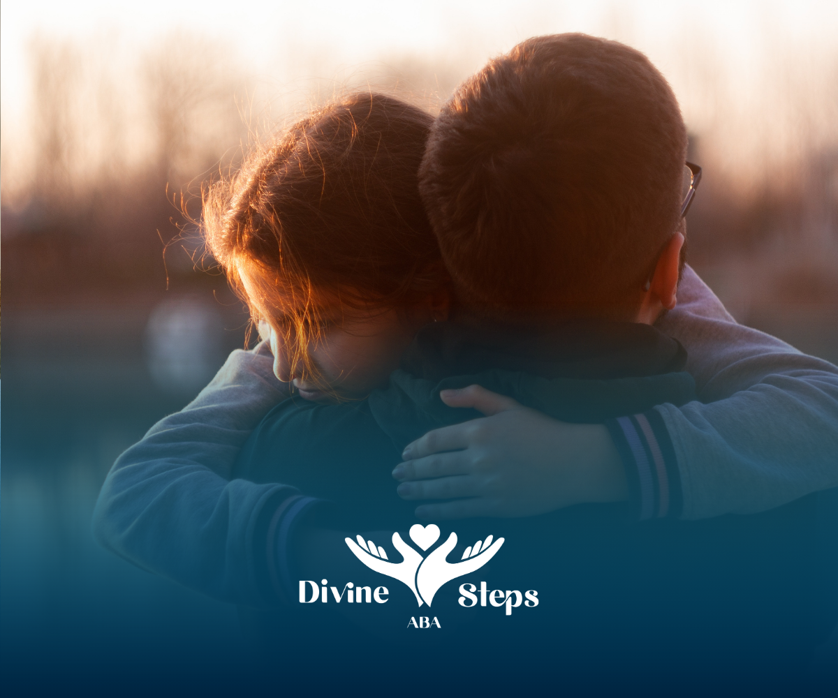 Two people embracing in a warm embrace, outdoors at sunset.