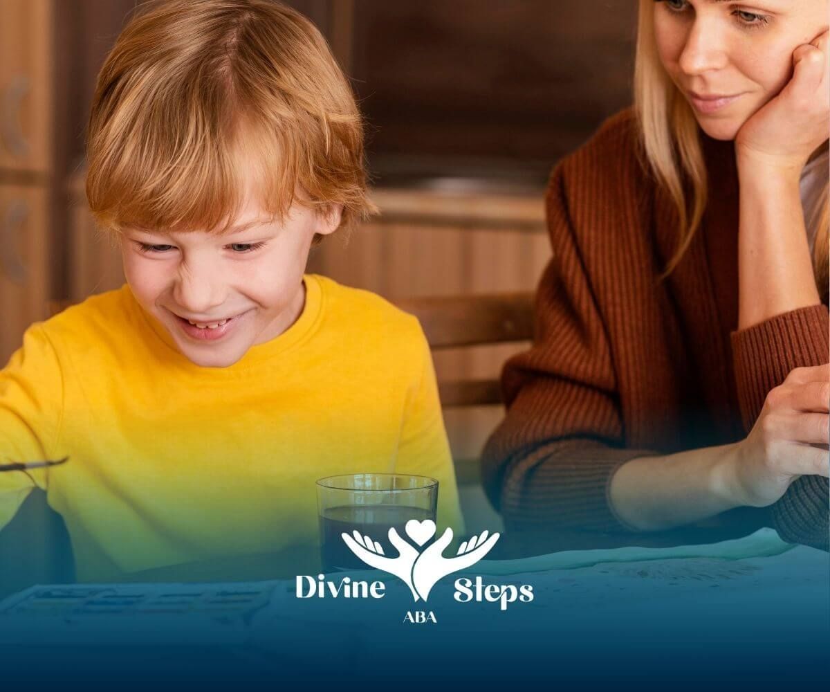 Autistic boy painting at table with parent nearby, encouraging creativity, & positive reinforcement