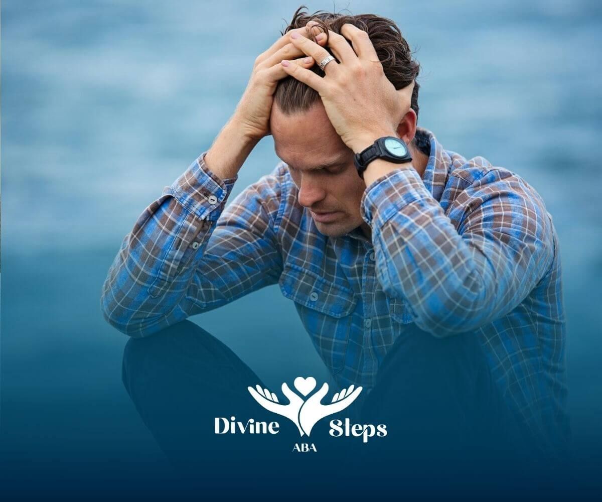 The autistic gentleman sitting by the water holding his head in distress after this ABA therapy. 