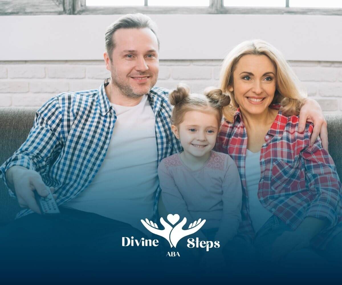 Happy family sitting on a couch together in ABA therapy, smiling at the camera.