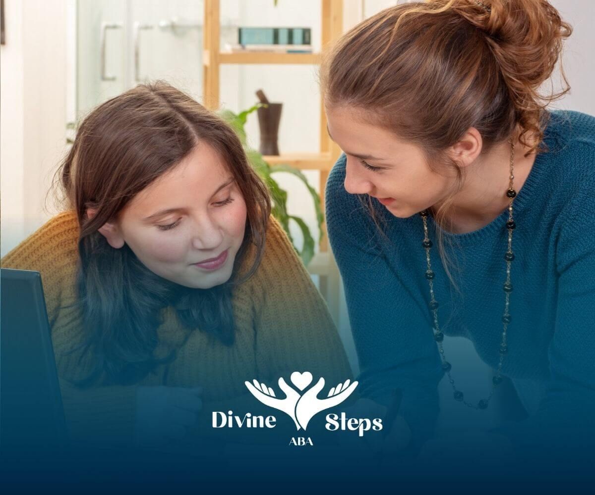 Therapist helping a teenage girl with learning activities at a desk during ABA therapy.