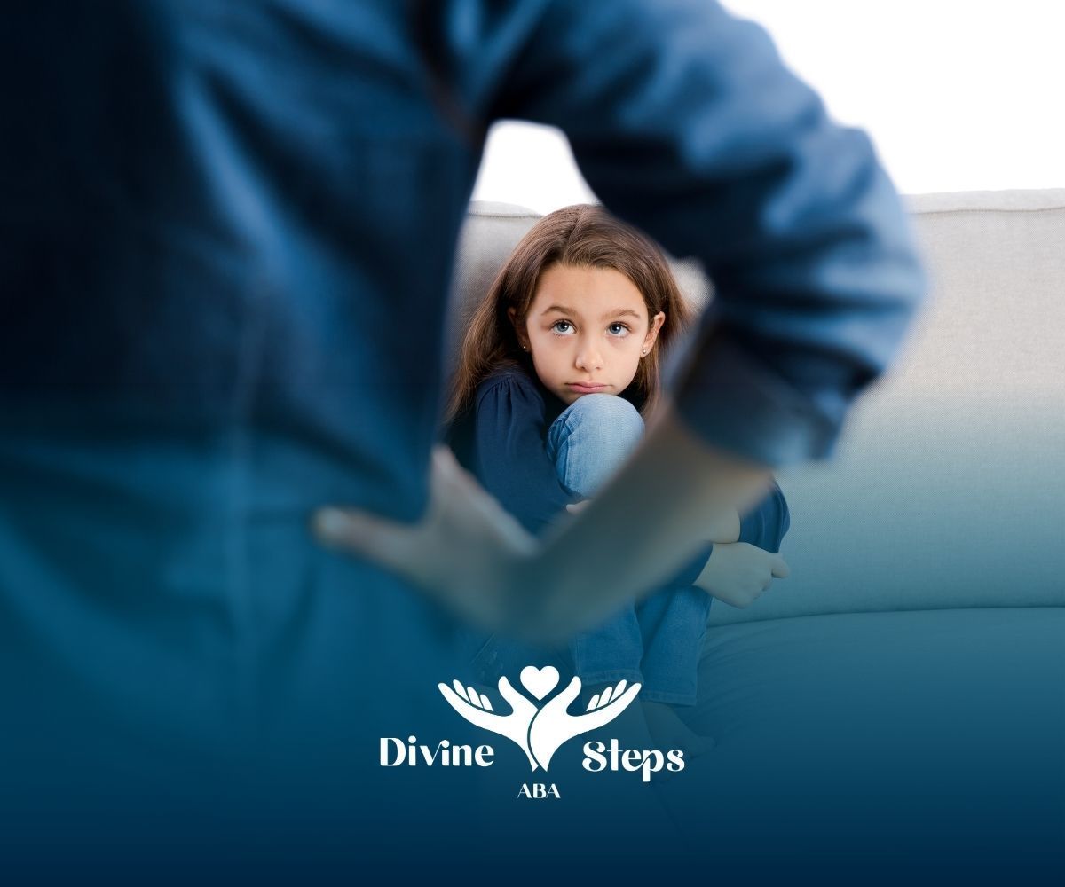 A child sits huddled, looking at someone whose arm is raised. Blue and white background with Divine Steps USA logo.