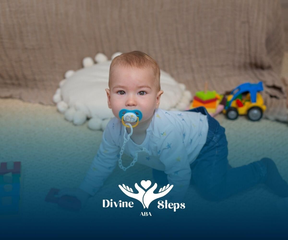 A baby with a pacifier in his mouth is crawling on the floor in ABA therapy.