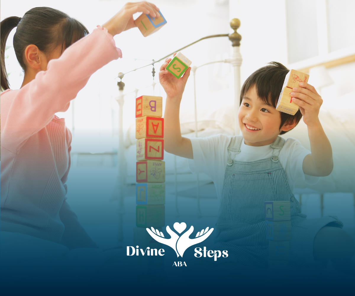 Two children build a block tower indoors, smiling.