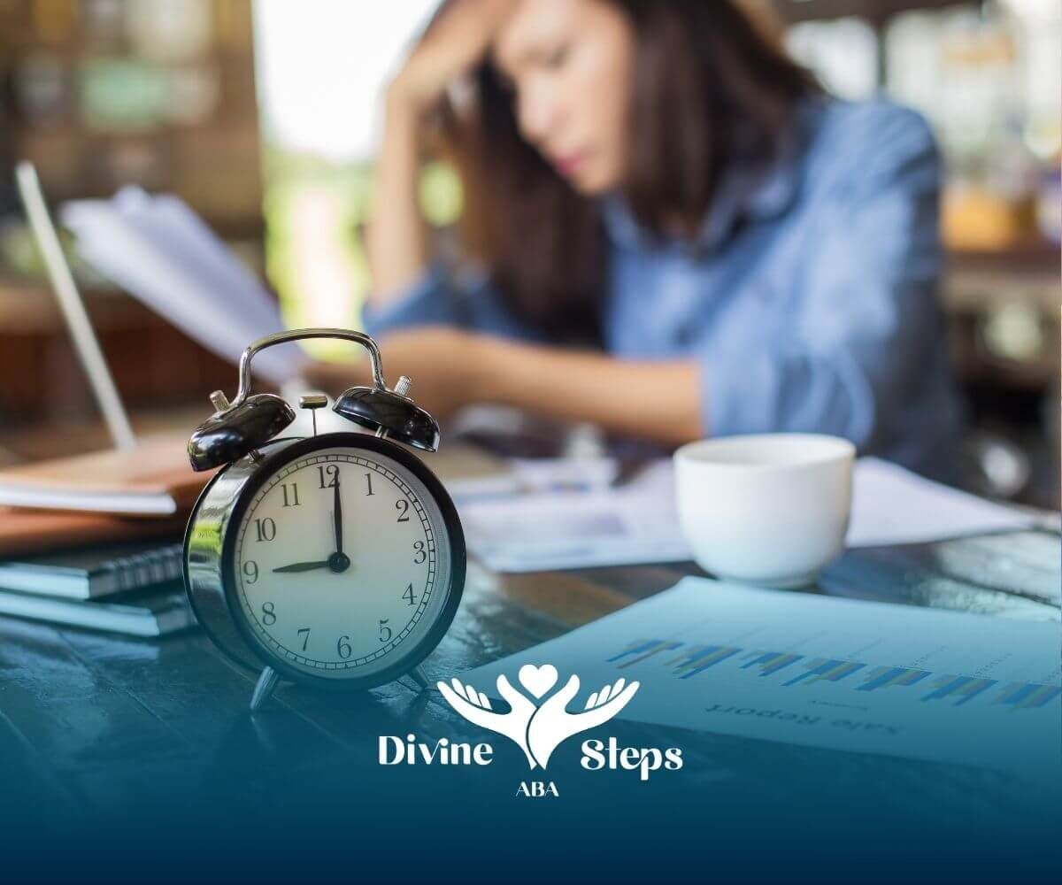 Alarm clock on desk with stressed therapist working on paperwork, symbolizing time commitment