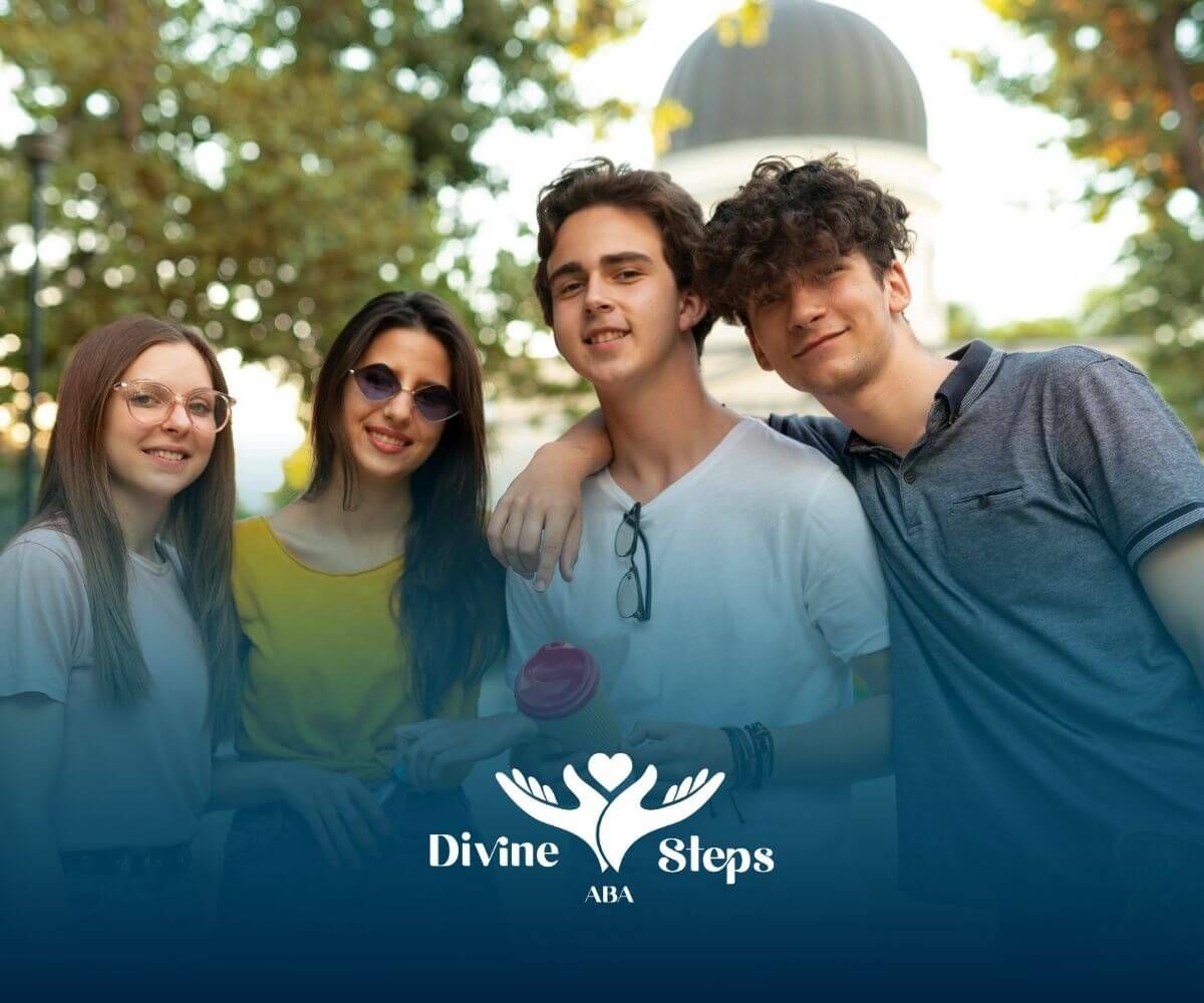 Four teenagers with autism stand outdoors smiling together, with one holding a skateboard.