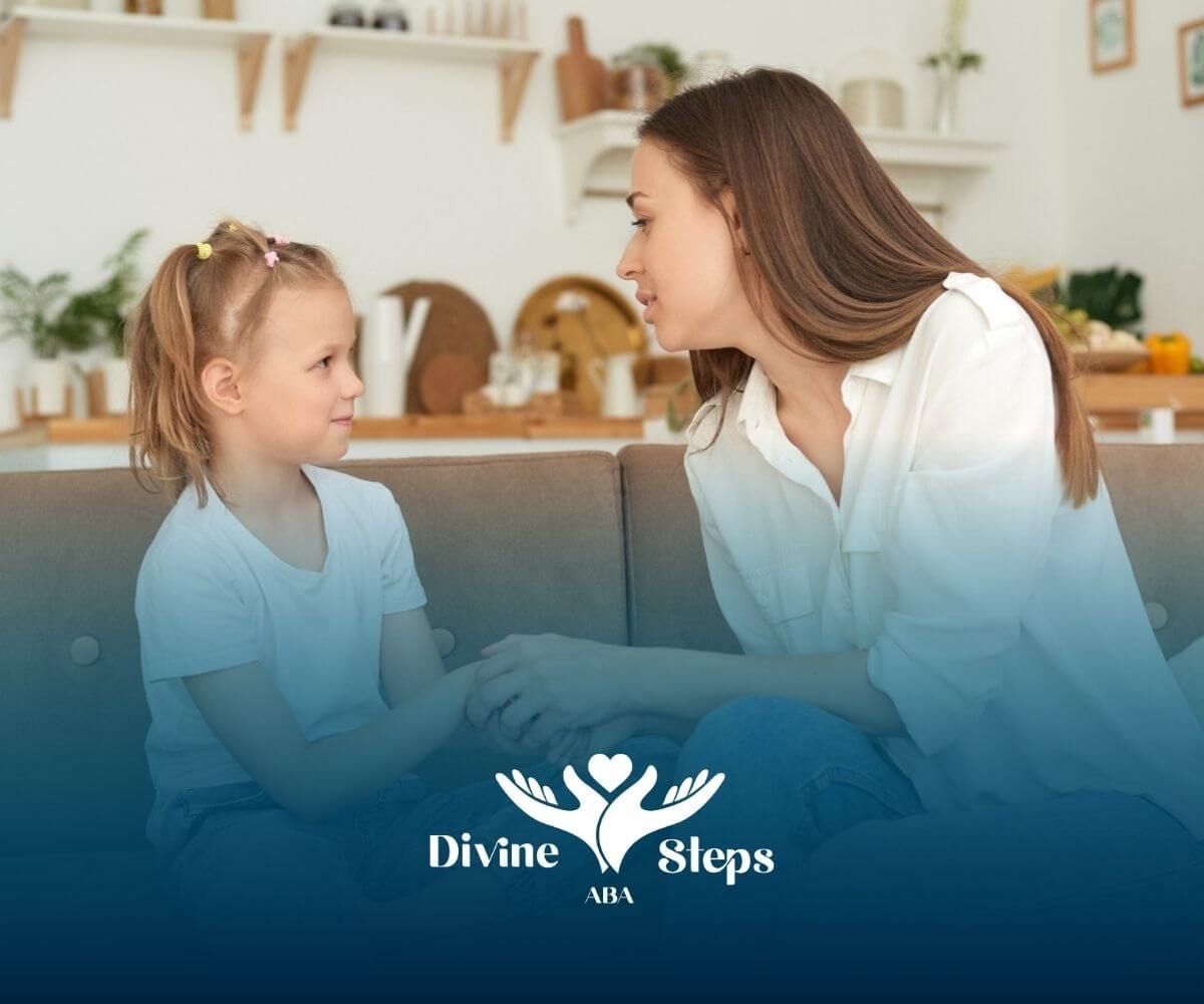 A woman with autism sits on a couch holding hands with a young girl as they talk.