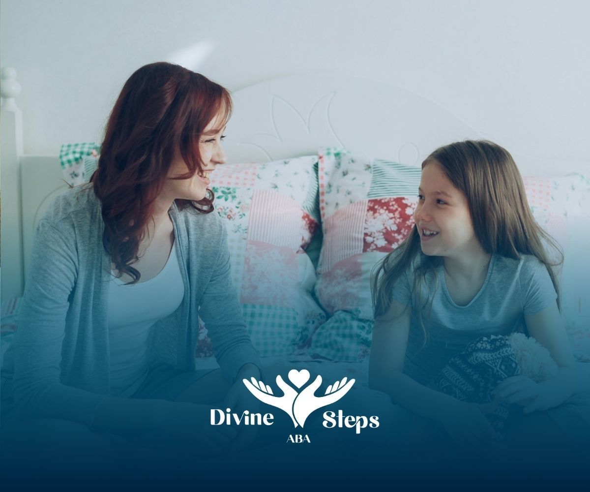An ABA therapist and an autistic child smiling and talking on bed during in-home ABA therapy in MD.