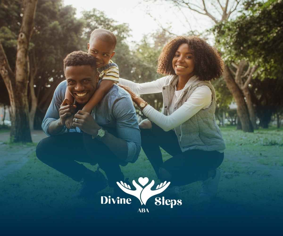 A joyful family in a park; a child sits on the father's back. The mother crouches beside them.