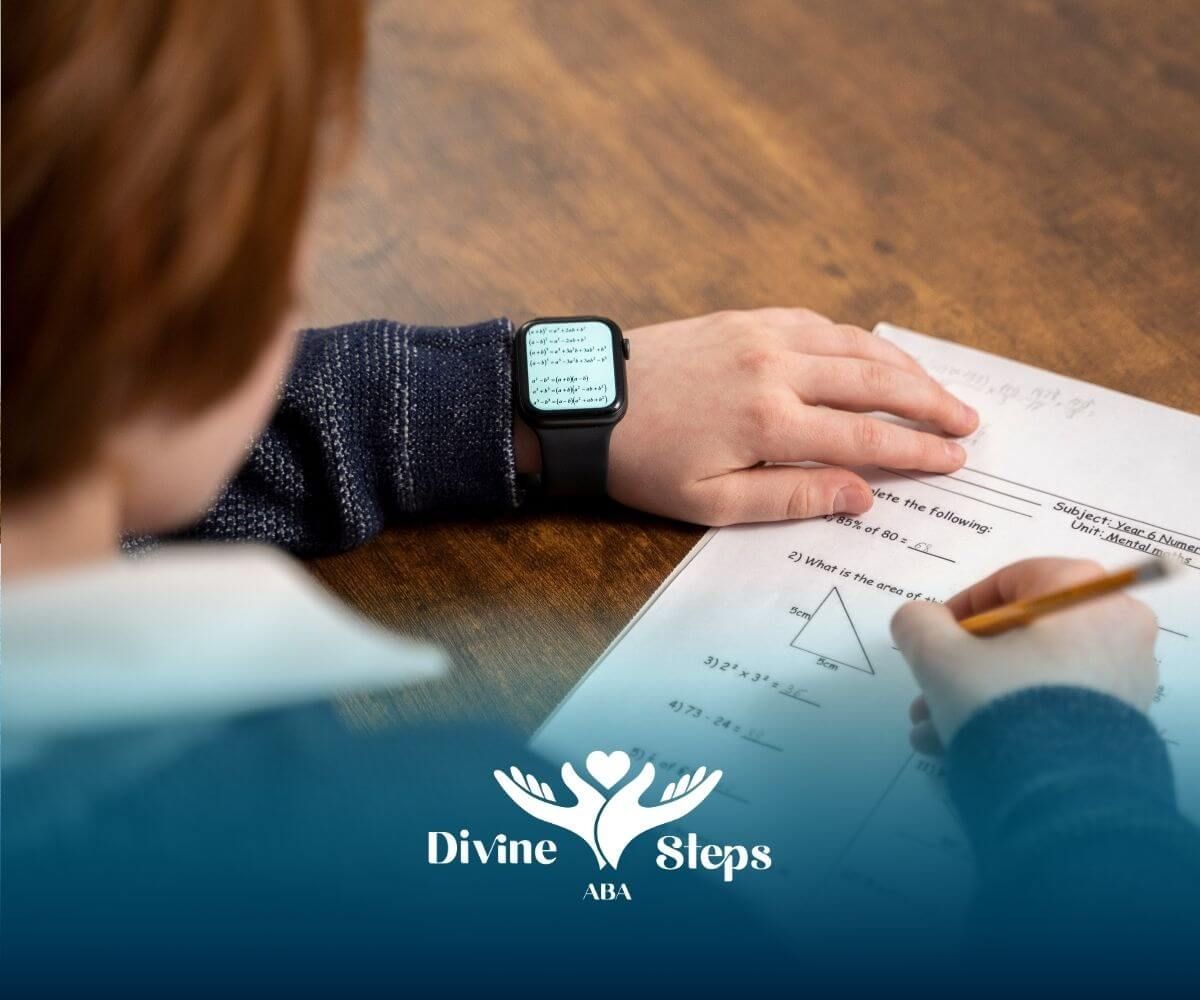 A close-up of an ABA student working on a math problem, wearing an Apple watch and holding a pencil.