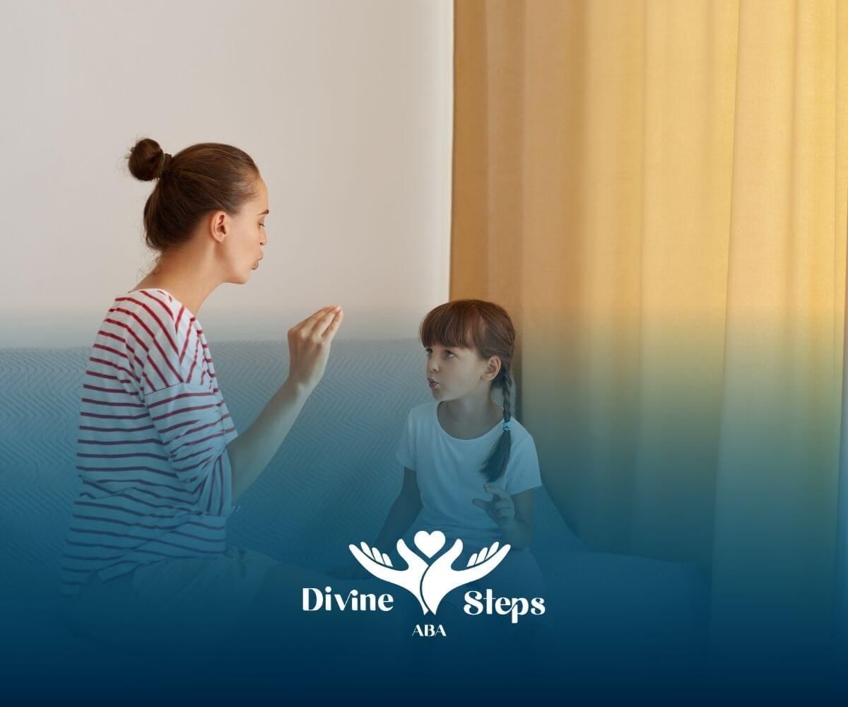  ​​Therapist sitting on couch talking calmly with autistic girl, using hand gestures ABA therapy.