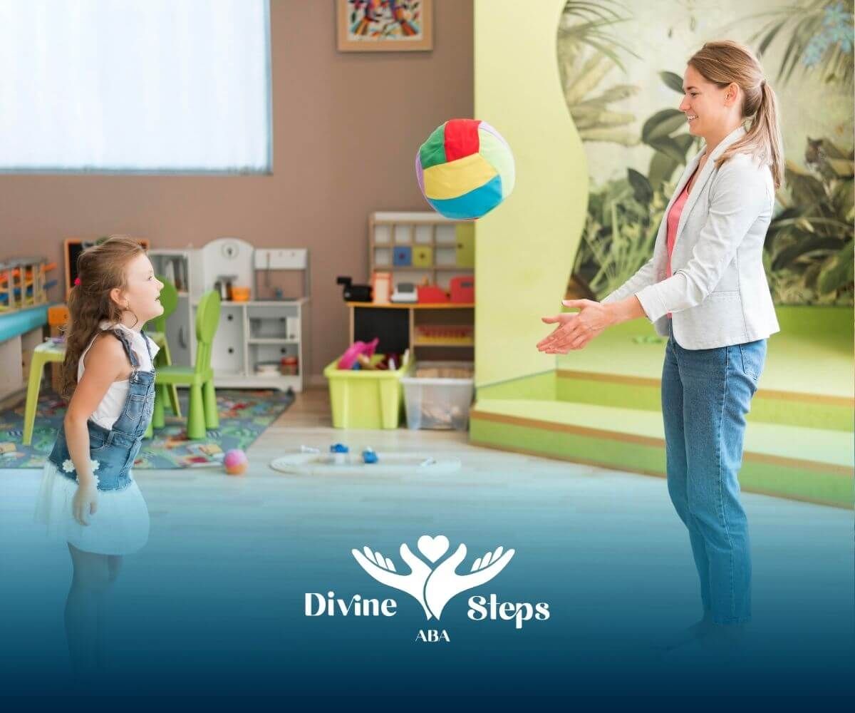 Therapist playing catch with autistic kid in sensory room, building coordination & engagement skills