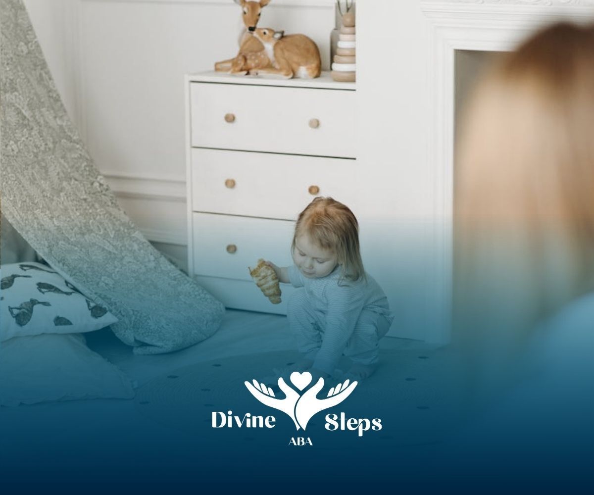 An autistic toddler playing with blocks on a rug while holding a croissant during ABA therapy in VA.