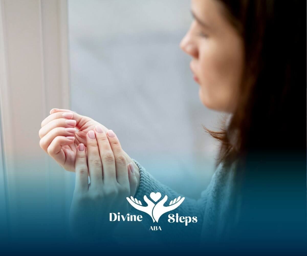 Therapist examining fingers near window, representing tactile sensitivity and sensory processing.