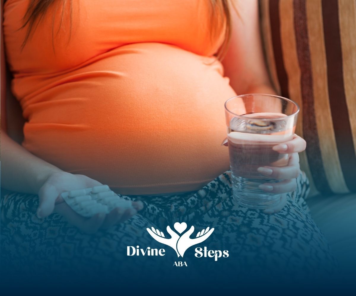 Pregnant woman holding pills and a glass of water.