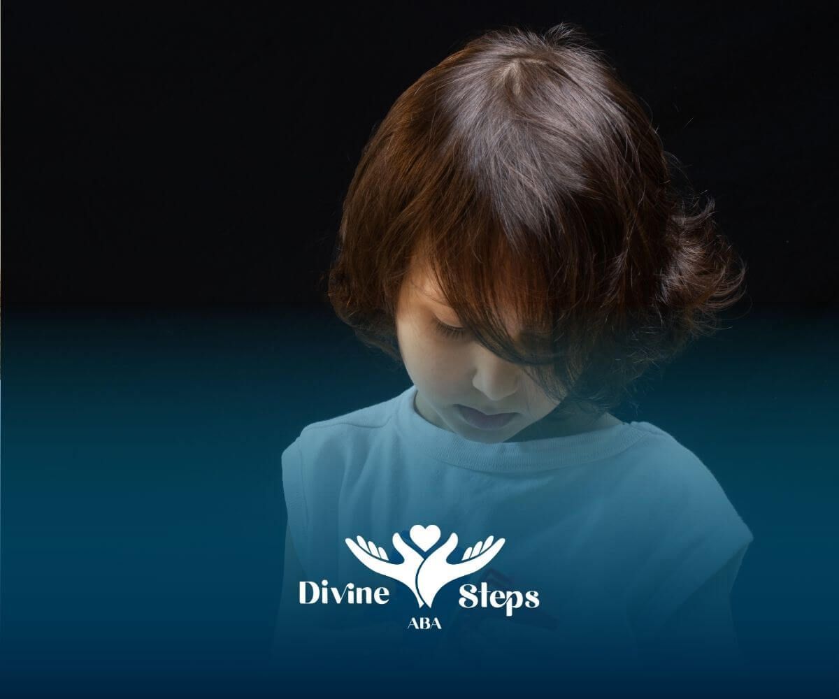 Young autistic child examining colorful plastic blocks while engaging in a quiet play activity.