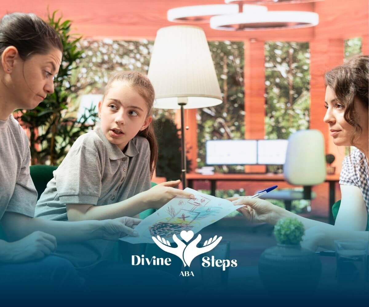 An autistic girl pointing out an illustration to an adult, engaging in conversation, while sitting.