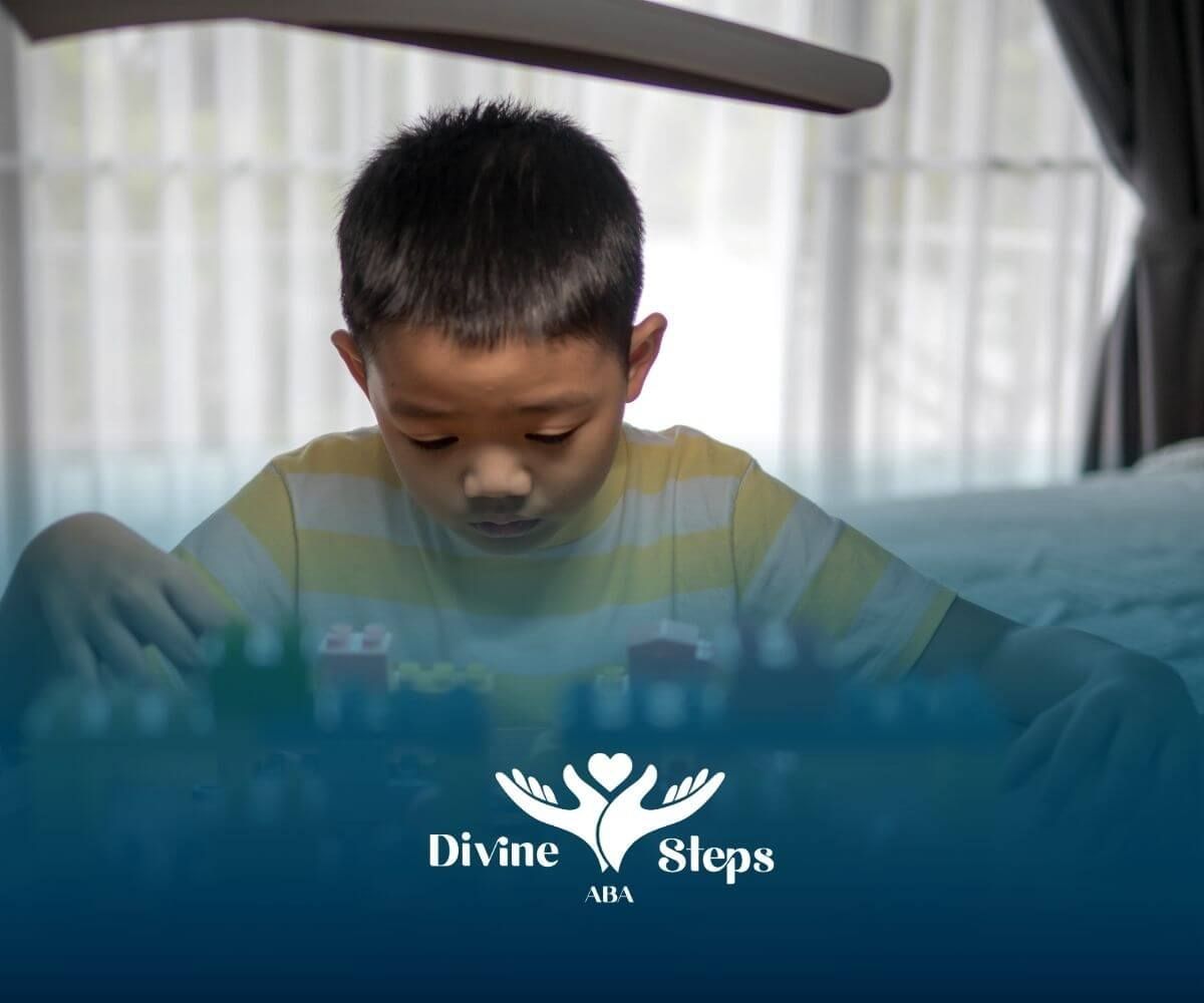 An autistic child focused on building colorful blocks indoors, showing concentration after therapy