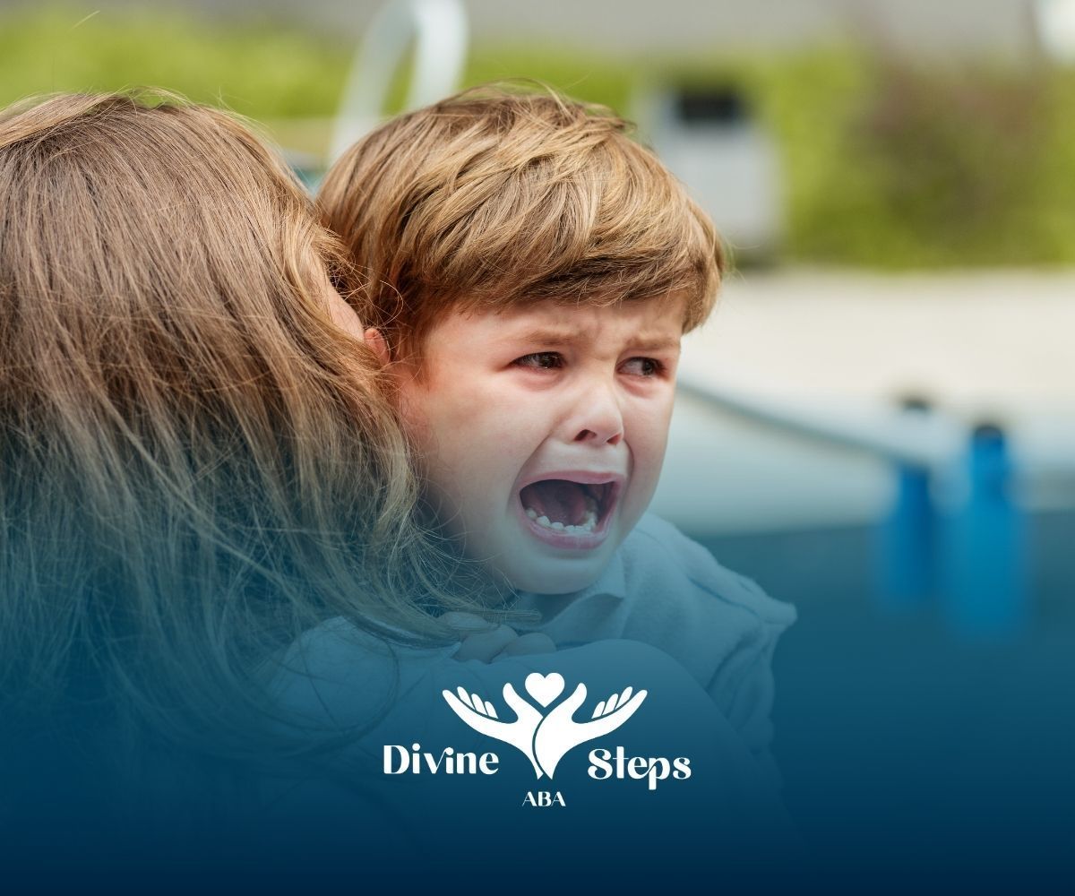Crying child being comforted by an adult. Blue background.