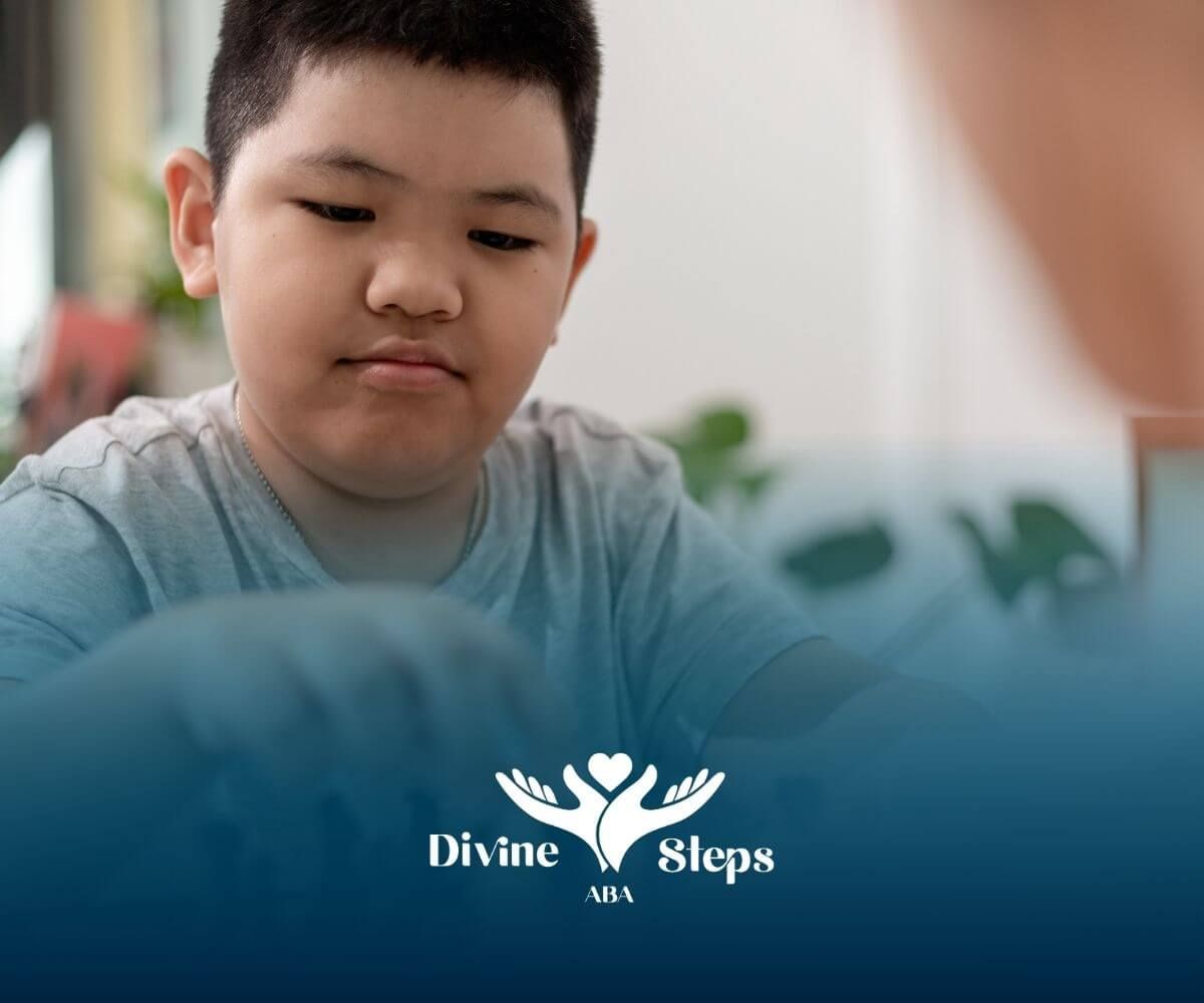 Autistic boy plays chess with therapist support to build planning, patience, and cognitive skills.