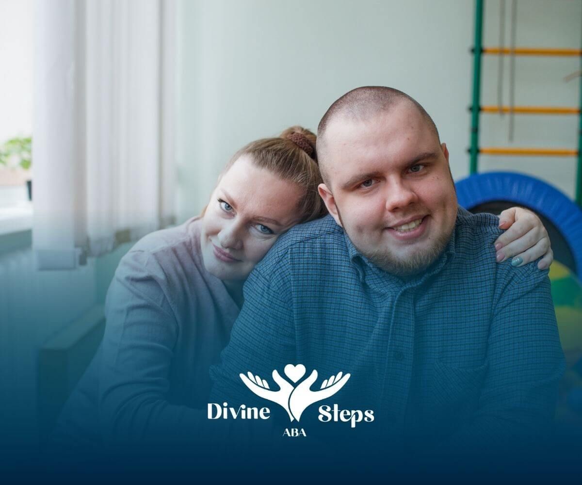 Adult with autism smiling with supportive partner in therapy room, showing inclusion and comfort
