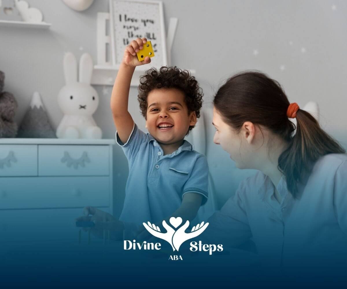 Autistic young boy holding a yellow block while playing educational game with therapist at a table.