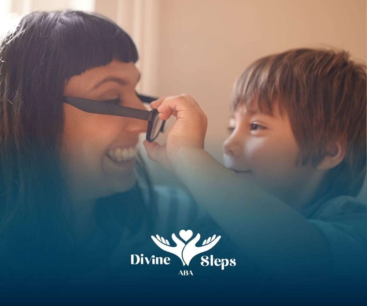 Autistic child is taking off a BCBA's sunglasses during ABA therapy.