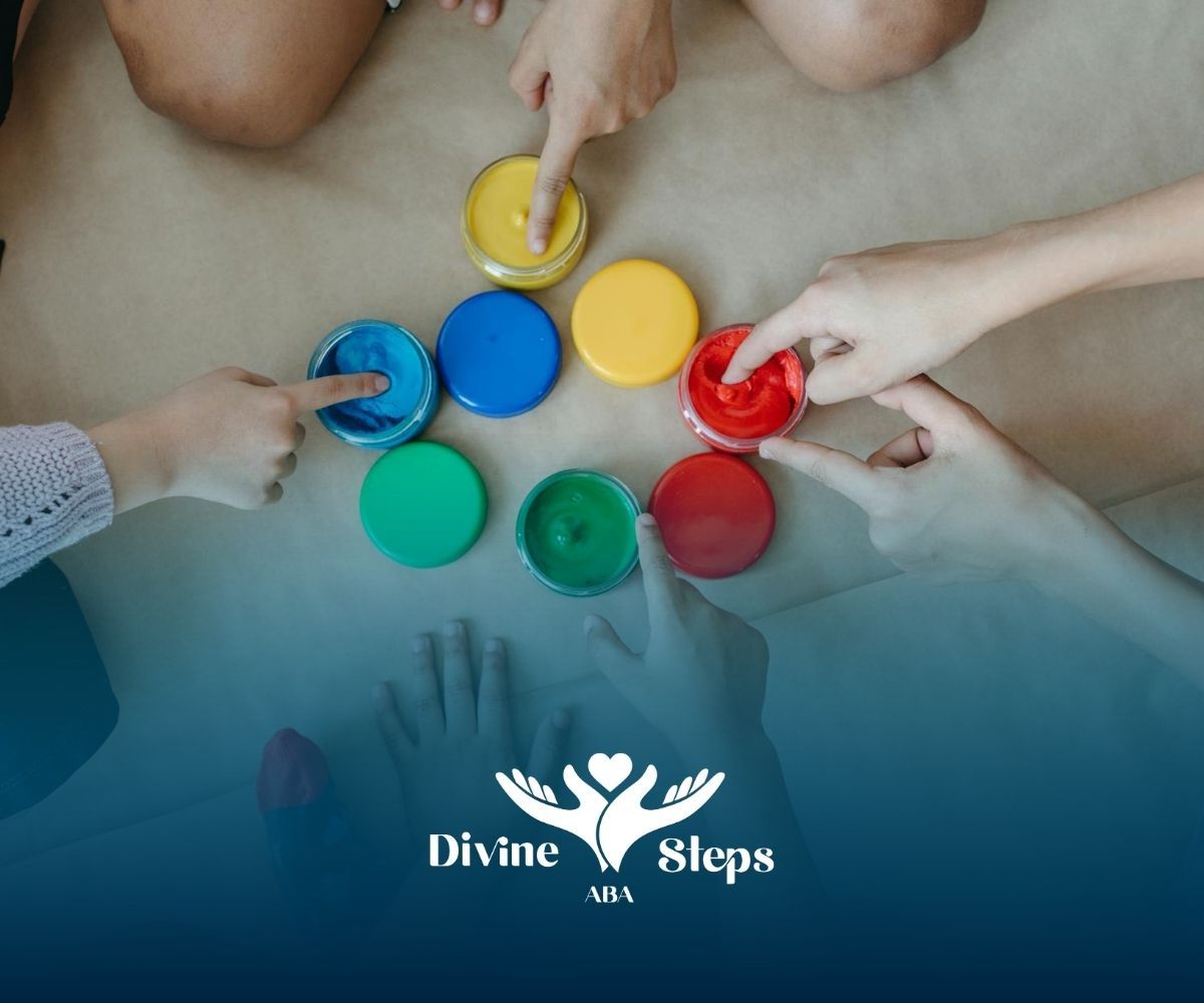 Autistic children’s hands pointing at paint containers during ABA therapy in North Carolina.
