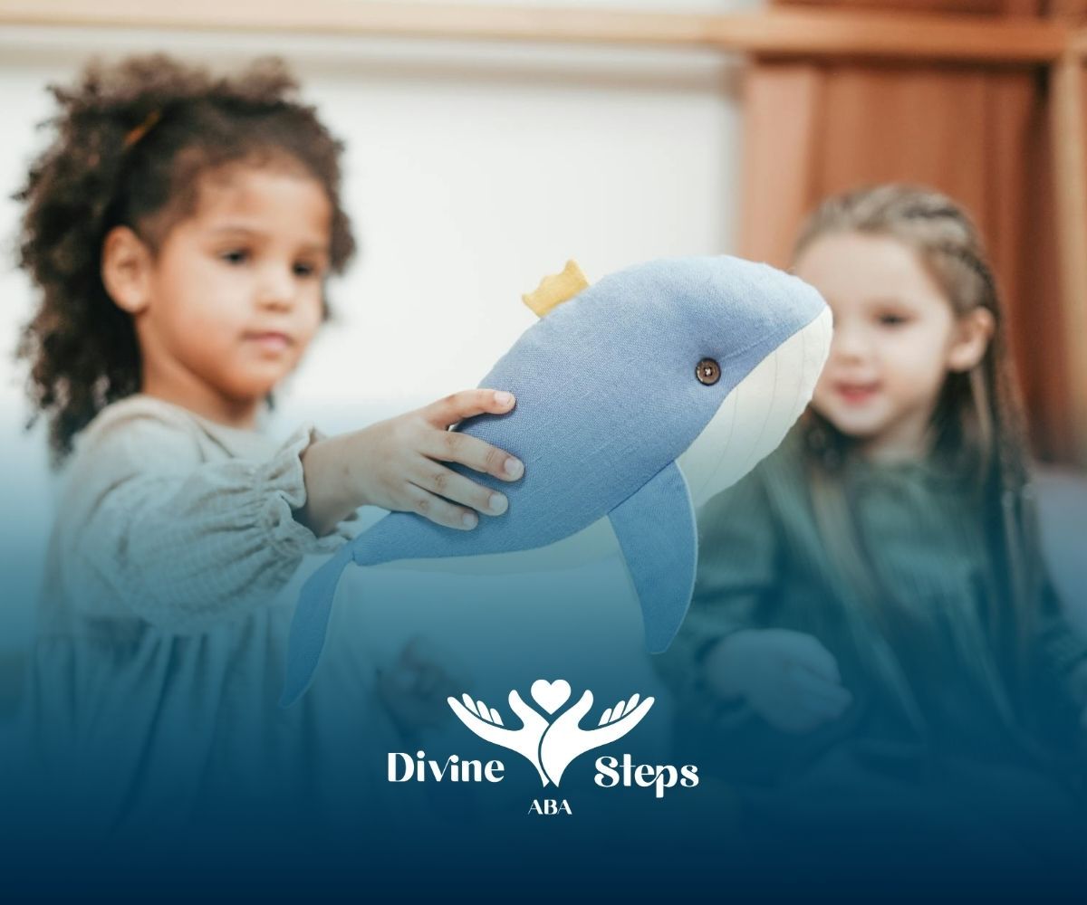 Autistic girl holding a whale toy while another child watches during ABA therapy at a daycare in VA.