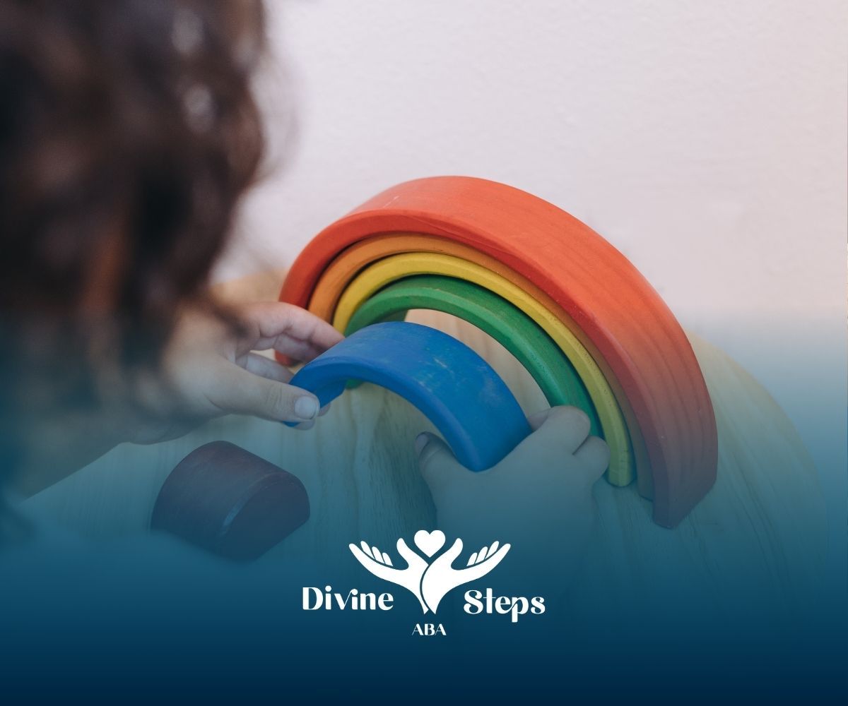 A person holding a rainbow with divine steps in the background