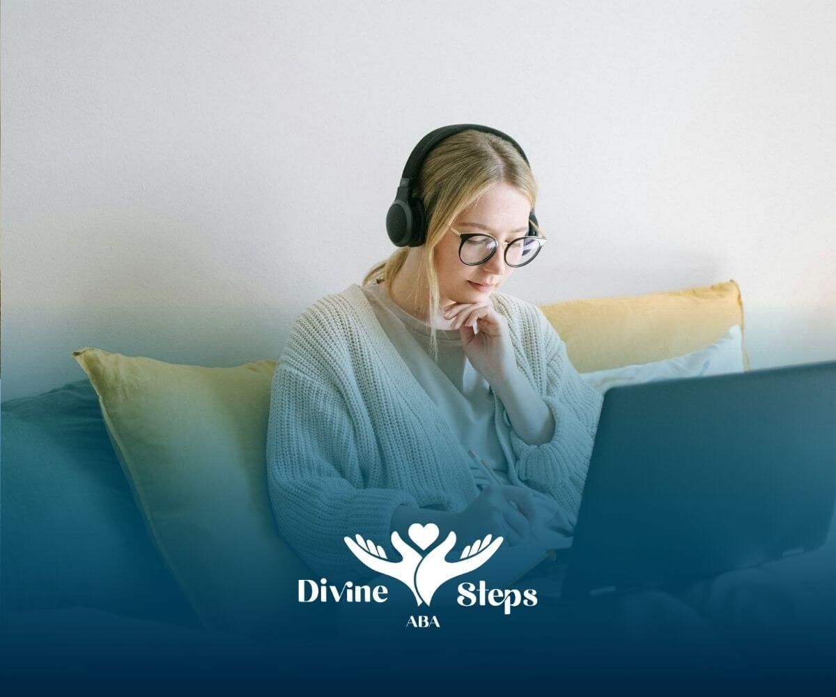 Female ABA therapist on bed with laptop, headphones on, taking notes and planning tasks in Maryland.